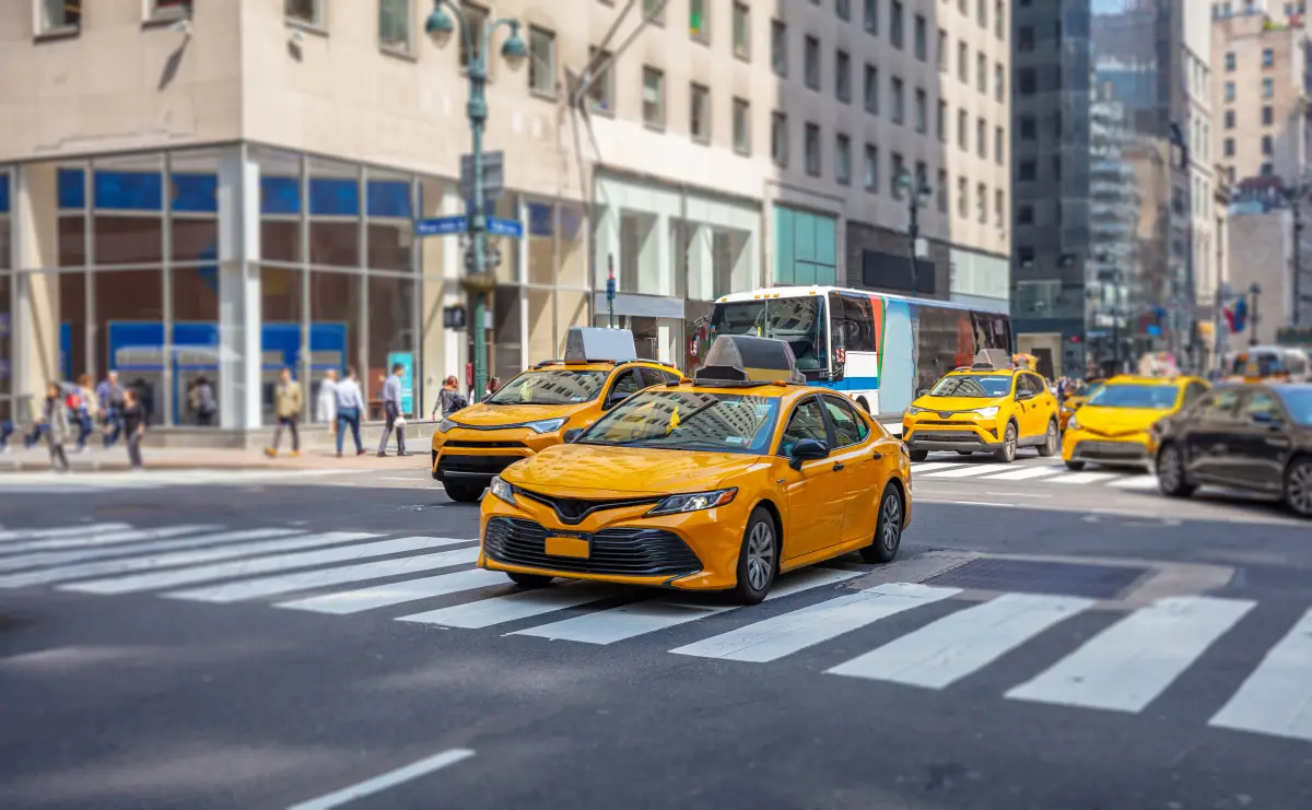 A busy city street with taxis in traffic