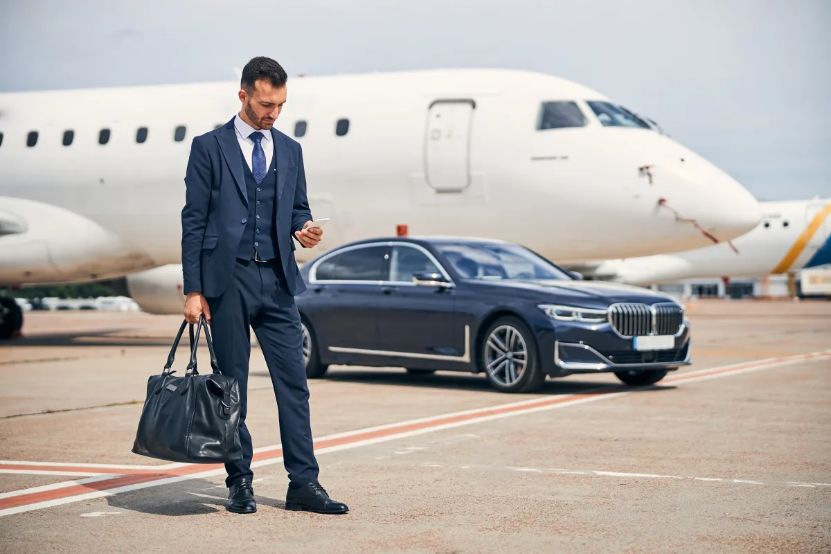 Traveller beside an Excel Taxi Yeovil car ready for a Bristol Airport transfer
